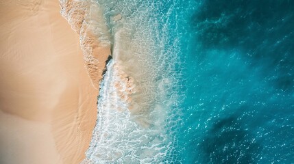 Aerial View of a Sandy Beach Meeting the Turquoise Ocean