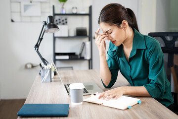 Work overtime tired of young women, Asian business Woman feels uncomfortable working.