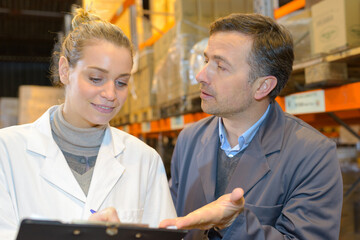 warehouse worker explaining to his supervisor