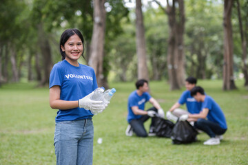 Fototapeta premium Volunteer Team Collecting Trash in Park to Promote Environmental Awareness and Community Cleanliness