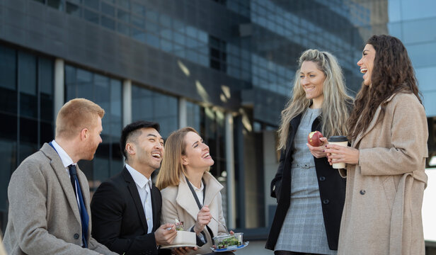 Multiracial business people enjoying a lunch break outdoor from office building