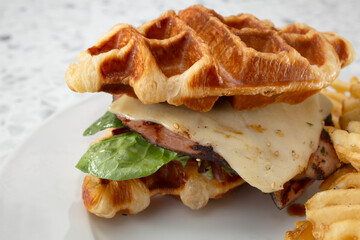 A closeup view of a croffle sandwich.