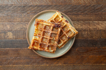 A top down view of some mochi waffles on a plate.