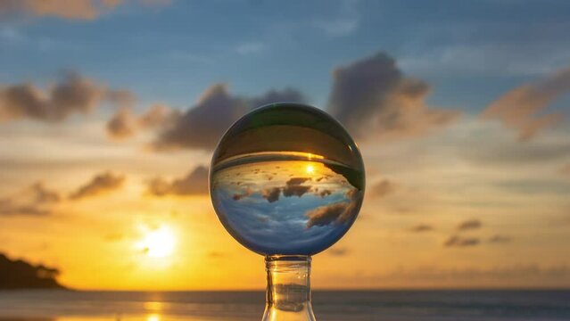 Time lapse view on the beach in beautiful sunset inside crystal ball.
Unconventional and beautiful natural views on the beach at sunset in a magic crystal ball. 
stunning cloud moving in colorful sky