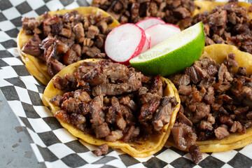 A closeup view of a plate of carne asada tacos.