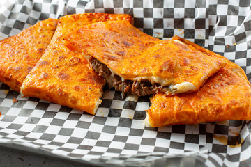 A view of slices of a birria quesadilla.