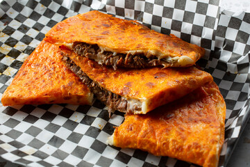 A view of slices of a birria quesadilla.