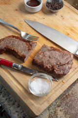 A view of a strip steak sliced in half.