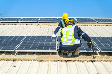 Worker Technicians are working to construct solar panels system on roof with sky and clound on background. Installing solar photovoltaic panel system. Renewable clean energy technology concept.