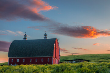 Red barn in the Palouse of eastern Washington state at sunset