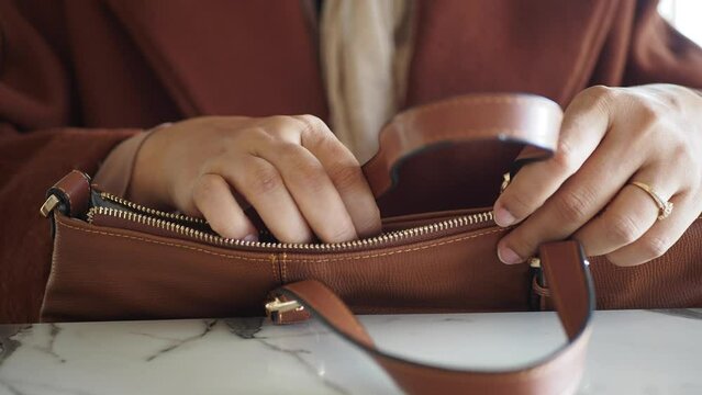 women looking for something in her purse