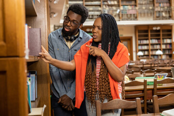 African american students discussing something in the library