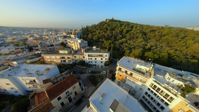Flying an fpv drone up a hill in Athens Greece near the acropolis and the parthenon during sunset. This is 30 fps.