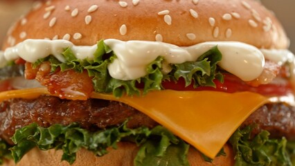 Close-up of home made tasty burgers on old olive wooden table.