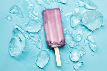 a popsicle or ice cream bar with ice, over a blue background