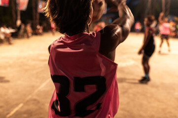 Basketball player shooting during night game,  community event, Philippines, Asia