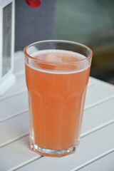 Cold refreshing grapefruit drink sitting on oustide outdoor table