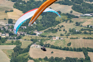 Sestola, Italy - 07 27 2024: Paraglider flies in the air. Aerial view of paragliding. Paraglider...