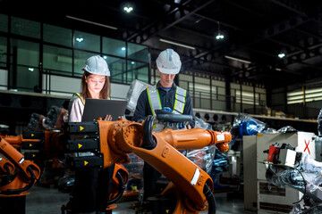Fototapeta premium team engineers inspecting on machine with smart tablet. Worker works at heavy machine robot arm. The welding machine with a remote system in an industrial factory. Artificial intelligence concept.
