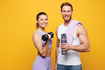 Young strong fitness trainer instructor sporty two man woman wearing blue clothes spend time in...