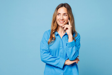 Young smiling happy woman she wear shirt casual clothes put hand prop up on chin, lost in thought...