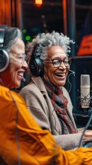 Obraz premium Two women laughing while recording a podcast