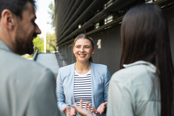 Group of successful young business people, leaders in marketing and motivation, stand in front of...