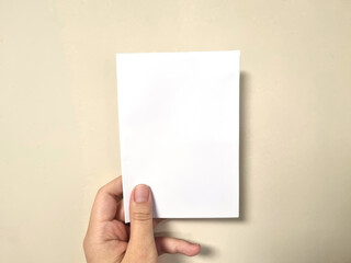 hand holding blank paper, Vertical Paper Mockup Image