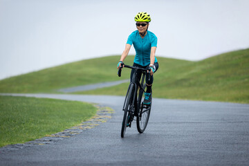 Fototapeta premium Woman biking on summer mountain trail