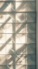 A tightly cropped image of a square frame with a repeating triangular pattern casting interesting shadows against a neutral wall.