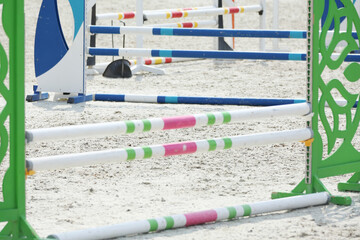 Horse obstacle course outdoors summertime. Poles in the sand for equestrian event