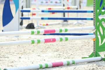  Horse obstacle course outdoors summertime. Poles in the sand for equestrian event