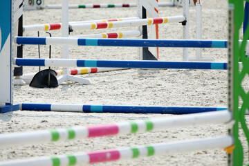  Horse obstacle course outdoors summertime. Poles in the sand for equestrian event