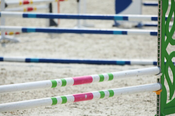  Horse obstacle course outdoors summertime. Poles in the sand for equestrian event