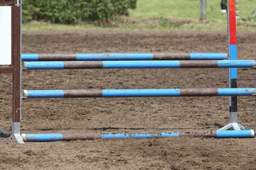  Horse obstacle course outdoors summertime. Poles in the sand for equestrian event