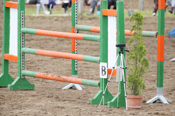  Horse obstacle course outdoors summertime. Poles in the sand for equestrian event