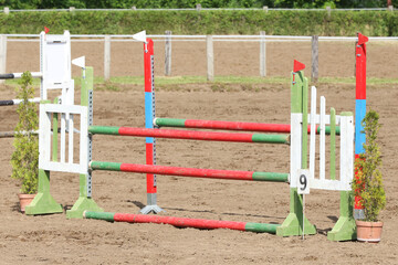  Horse obstacle course outdoors summertime. Poles in the sand for equestrian event