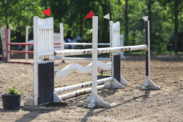  Horse obstacle course outdoors summertime. Poles in the sand for equestrian event
