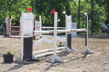  Horse obstacle course outdoors summertime. Poles in the sand for equestrian event