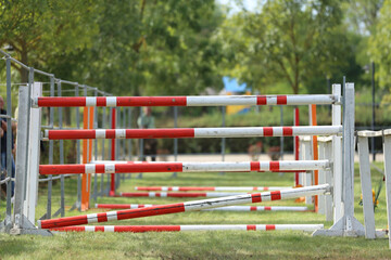  Horse obstacle course outdoors summertime. Poles in the sand for equestrian event