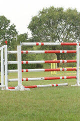  Horse obstacle course outdoors summertime. Poles in the sand for equestrian event