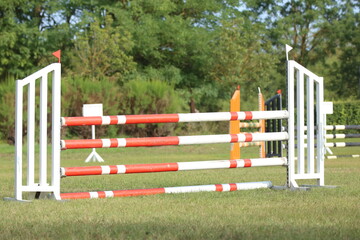  Horse obstacle course outdoors summertime. Poles in the sand for equestrian event