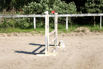  Horse obstacle course outdoors summertime. Poles in the sand for equestrian event