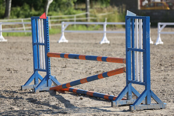 Horse obstacle course outdoors summertime. Poles in the sand for equestrian event