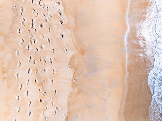 Amazing Top view sea beach landscape background,Summer sea waves crashing on sandy shore seascape background,High angle view ocean nature background