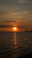 Vertical orientation sunset by the beach with vibrant colors