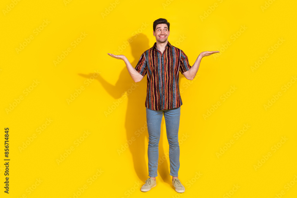 Sticker full size photo of nice young man hold empty space wear shirt isolated on yellow color background