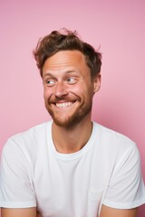Fototapeta premium Happy Scandinavian man, 25 years old, winking on a pastel light pink background