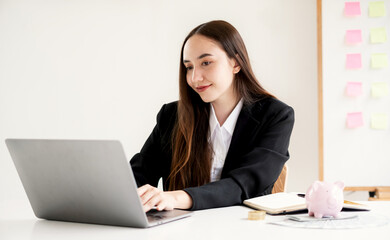 Asian businesswoman sit at their desks and calculate financial graphs showing results about their investments and plan successful business growth process