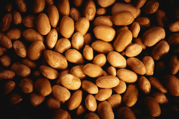 Brown beans haricot for making stews. Sweet candies, pebbles, backdrop